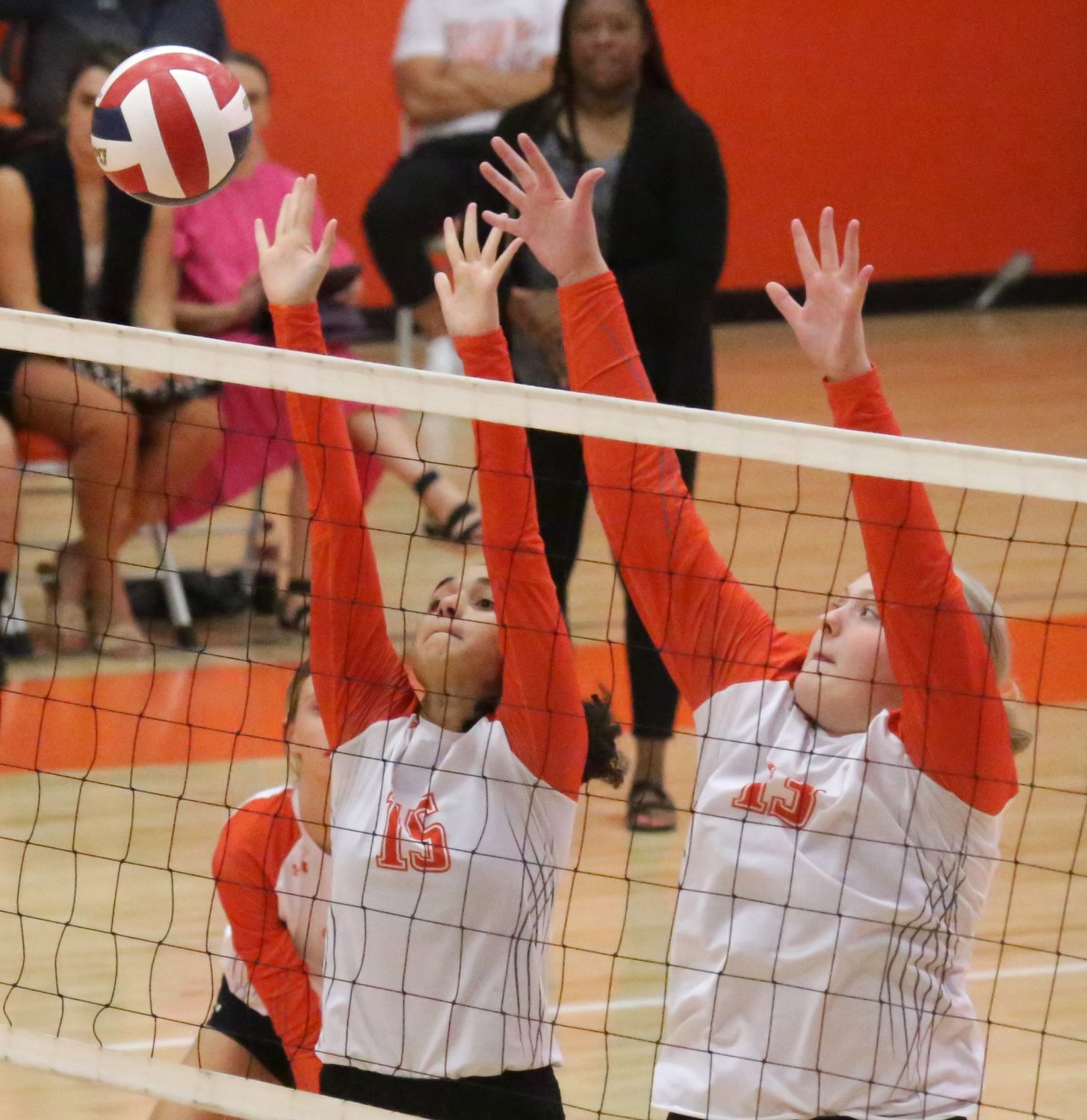 Lady Jackets Kyra Jackson (left) and Jocelyn Whitehead put up a block in action against Cayuga.